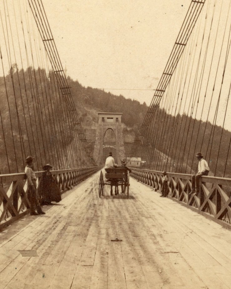 Composite image combining Serrell’s iron wire suspension bridge with Brunel’s tower