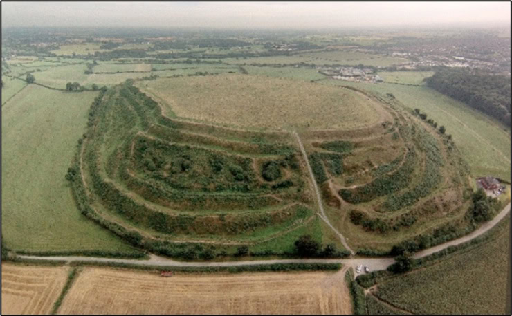 Old Oswestry Hillfort from the air, looking towards its western entrance, with car park visible beneath. Photo by Oswestry Borderland Tourism on Wikimedia. Attribution-ShareAlike 4.0 International