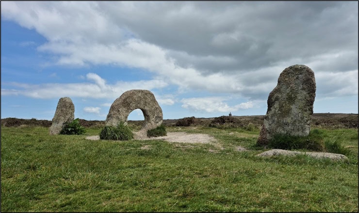 Men-an-Tol as it stands today, likely very different from its original design. An engine house, emblematic of Cornwall’s later mining history, can be seen in the distance. Photo by Mike Edwardson.
