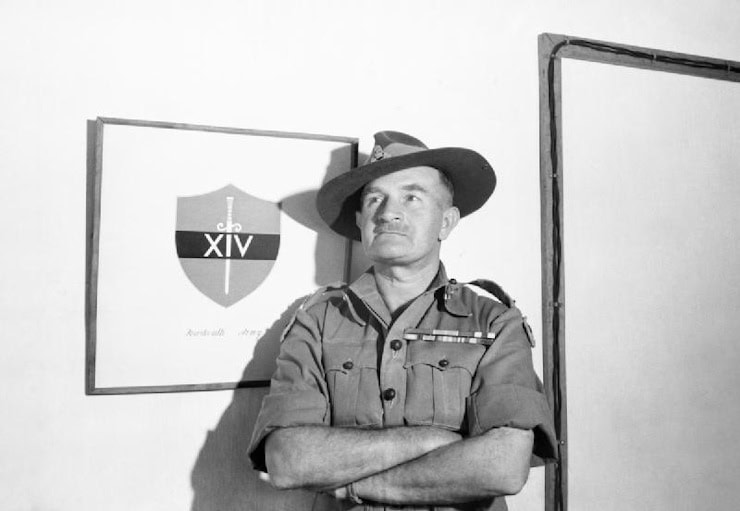 Lieutenant-General Sir William 'Bill' Slim with the insignia of the 14th Army behind him, 5th March 1945. PD. WC.