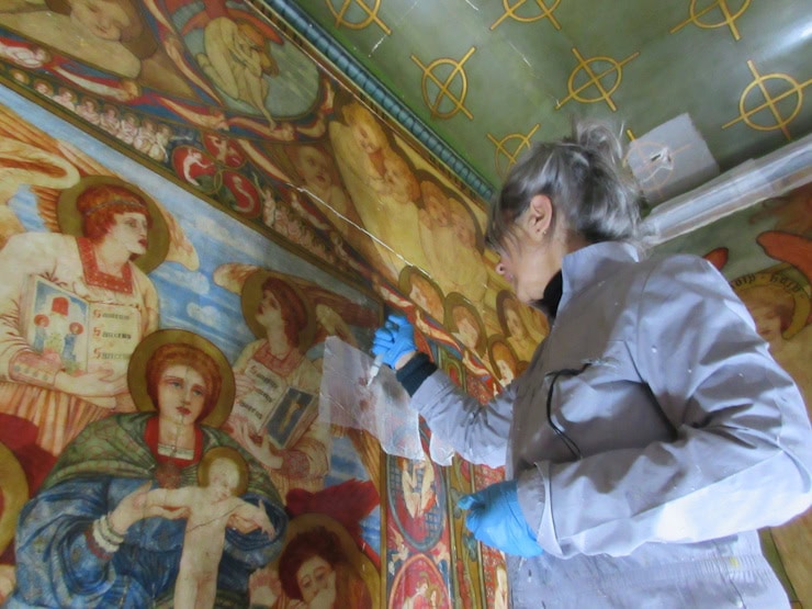 Mortuary chapel north wall mural - conservator treating cracked plaster. Author's own.