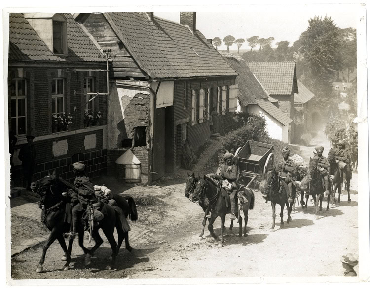 Indian cavalry troop of 36th Jacob's Horse marching through a French village near Fenges, August 1915. WC PD.