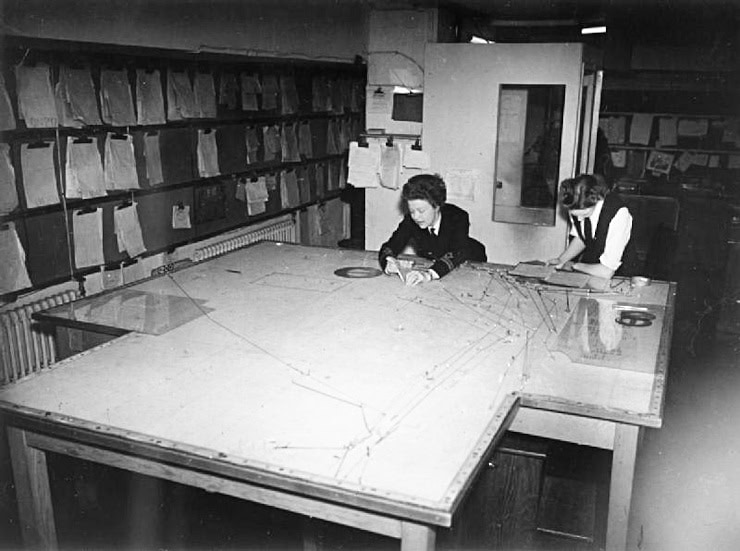 Two Wrens at work at the convoy plot in the operations room, Derby House, Liverpool. WC PD.