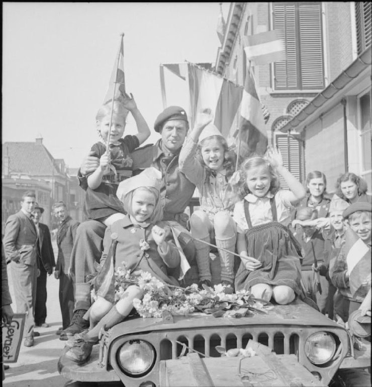 Dutch children ride on a jeep during the liberation of Velp, 16 April 1945.. WC PD.