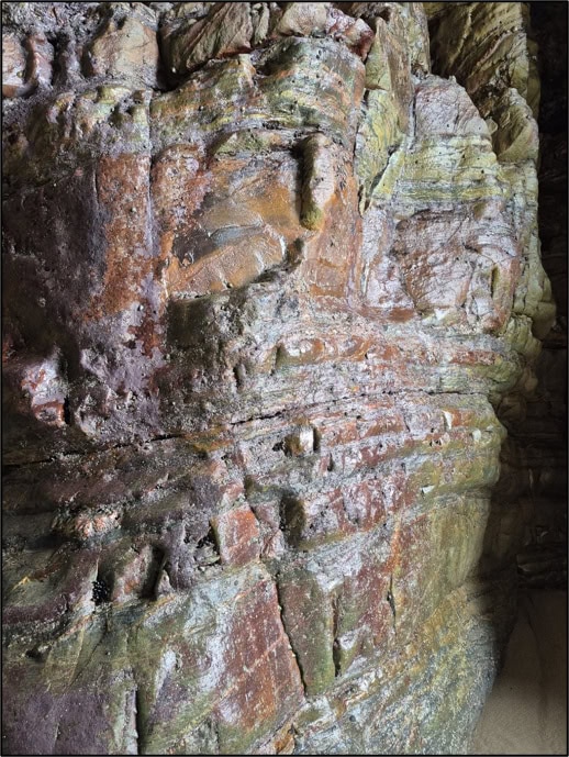 Bolster’s blood? The reddish hue of the rocks inside the Cave. Photo by Mike Edwardson.