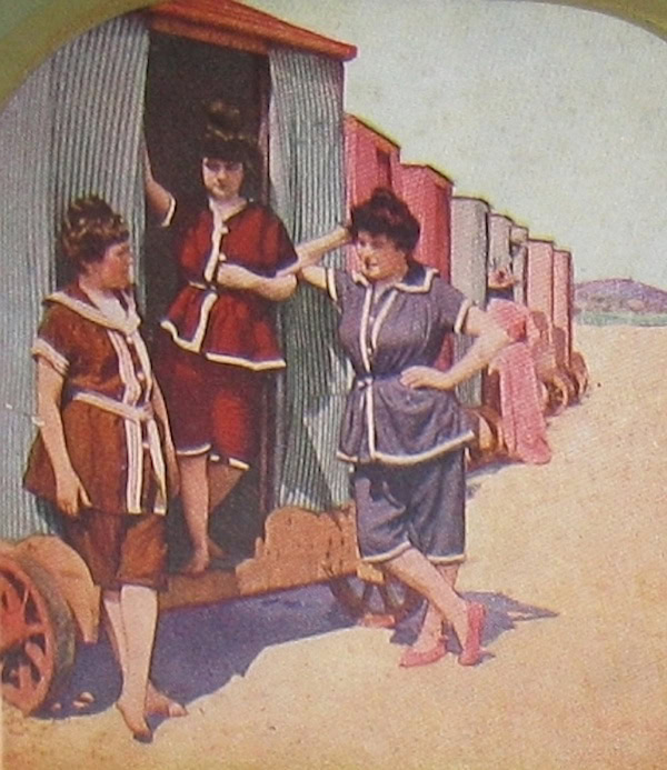 Women by a bathing machine, 1902. WC PD.